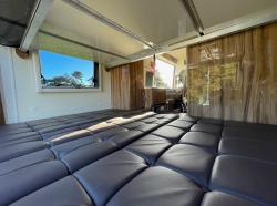 seating area made to double bed in the motorhomw