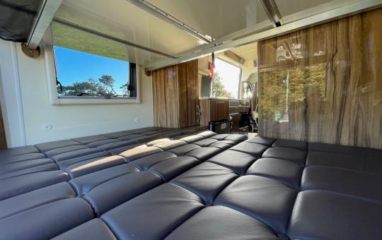 seating area made to double bed in the motorhomw